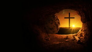 Easter and Good Friday concept, empty tomb with cross on mountain with amazing sunrise