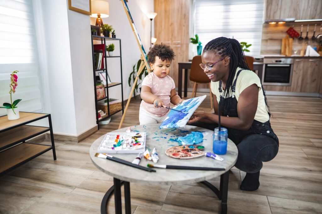 Joyful indoor painting session for parent and child