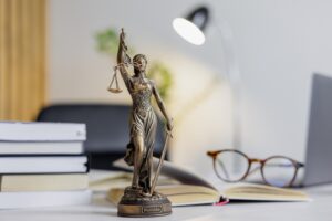statuette of Themis, the goddess of justice, stands on a table in the office of a law firm or