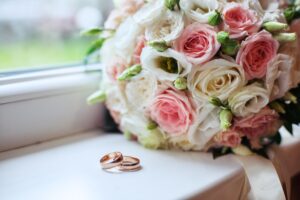 Wedding bouquet and rings. The concept of marriage and love.