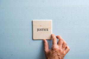 Word Justice printed on wooden tile